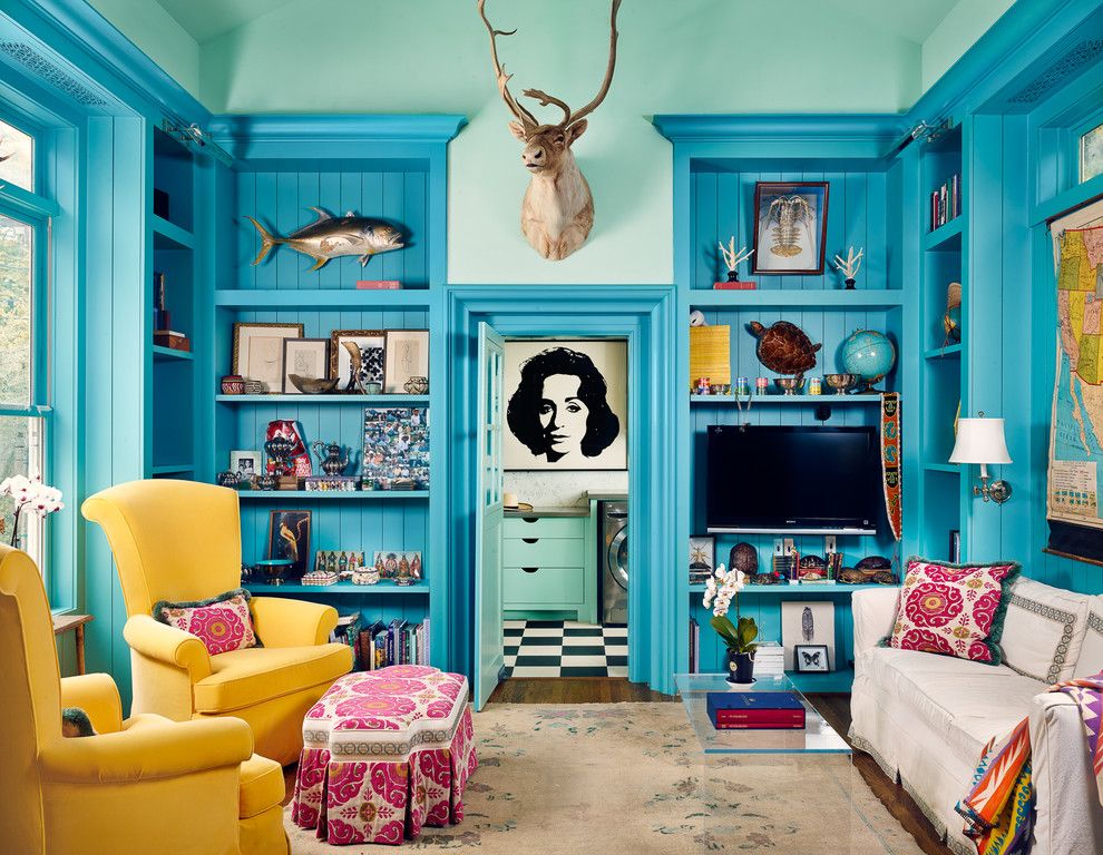 living room in teal and a pairs of yellow chairs